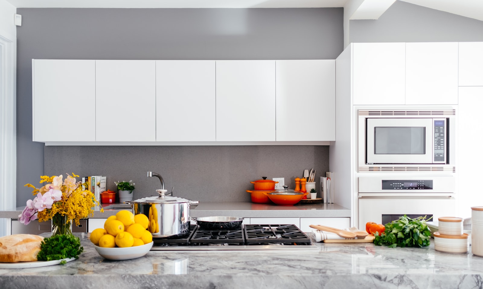 A bright, spotless kitchen with sunlight on clean worktops